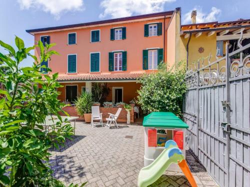 uma casa com um parque infantil em frente a uma casa em Belvilla by OYO Casa Teresa em Camaiore