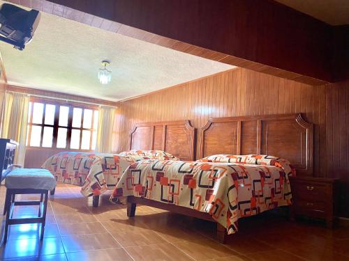 Tempat tidur dalam kamar di Posada Castillo