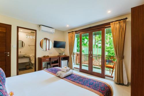 Tempat tidur dalam kamar di Gana Hotel & Restaurant