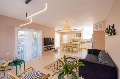 a living room with a couch and a table at Eilat vacation house דירות נופש אילת in Eilat