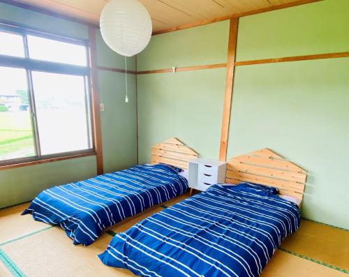 A bed or beds in a room at ikibase Guest House