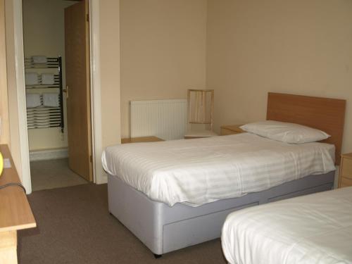 a hotel room with a bed and a desk at Jolly Brewers Free House Inn in Bishops Stortford