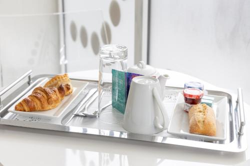 a tray with bread and croissants on a shelf at Blc Design Hotel in Paris