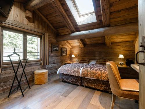 a bedroom with a bed in a wooden cabin at Appartement La Clusaz, 5 pièces, 8 personnes - FR-1-304-212 in La Clusaz