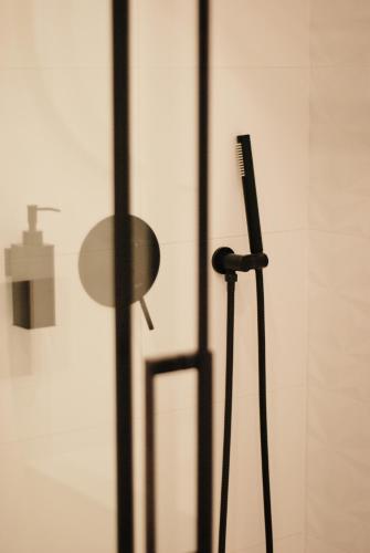 a hair brush sitting next to a glass door at BOOGIE Home Kamienica Łódzka in Łódź