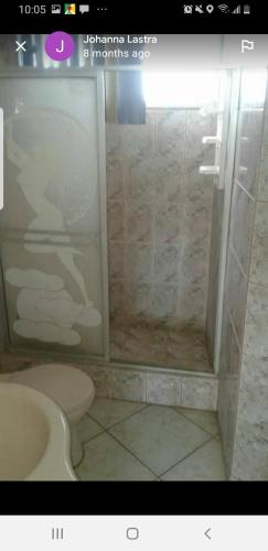 a bathroom with a shower with a toilet and a sink at Casa blanca Atacames in Atacames