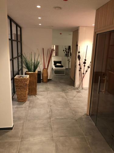 a hallway with a tile floor in a building at Hotel Schempp in Bobingen
