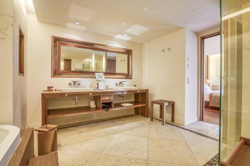 a bathroom with a sink and a mirror at Wald & Schlosshotel Friedrichsruhe in Friedrichsruhe