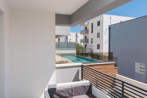 an apartment balcony with a view of a swimming pool at Villa Lovric in Makarska
