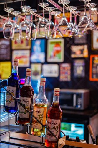 a group of bottles of alcohol sitting on a bar at HOTEL CYPRESS in Nadiad