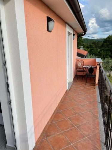 a balcony of a house with a table and chairs at Apartma Mija-Dekani in Dekani