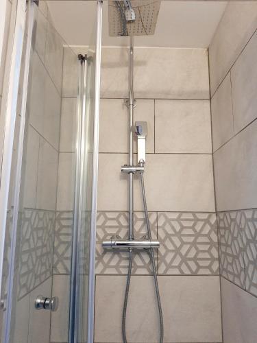 a shower with a glass door and a shower at Salisbury Guest House - free parking in York