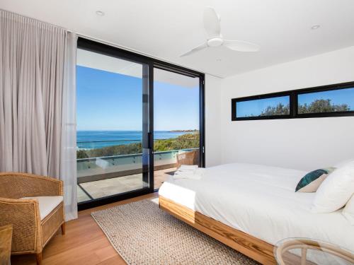 um quarto com uma cama e vista para o oceano em Banksia I Absolute Beachfront em Culburra Beach