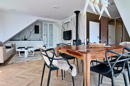 a dining room with a wooden table and chairs at Nautica Resort in Giżycko