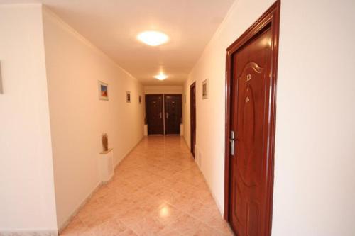 a hallway with a wooden door and a hallway with a hallway at Hotel Mon Caprice in Bucharest