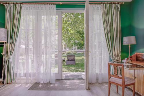a room with a door open to a yard at Wald & Schlosshotel Friedrichsruhe in Friedrichsruhe