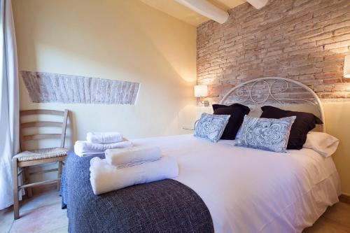 una camera da letto con un grande letto bianco con un muro di mattoni di Friendly Rentals Santa Monica a Barcellona