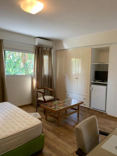 a bedroom with a bed and a coffee table in a room at Rivitel Marousi Apartments in Athens