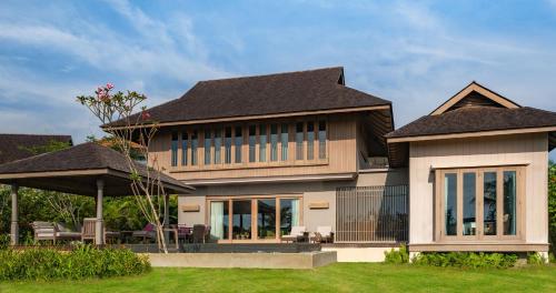 a large house with a black roof at Anantara Desaru Coast Resort & Villas in Desaru