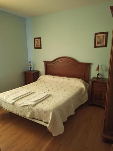 a bed in a bedroom with two nightstands and a bed sidx sidx sidx at La Bimborra in Becedas