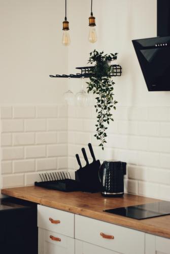 a kitchen with white walls and a counter with knives at BOOGIE Home Kamienica Łódzka in Łódź