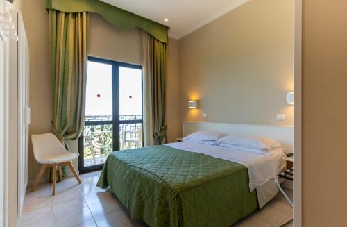 a hotel room with a bed and a window at Hotel Villa Igea in Sorrento