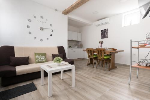 a living room with a couch and a table at Apartmani kod Marka in Požega