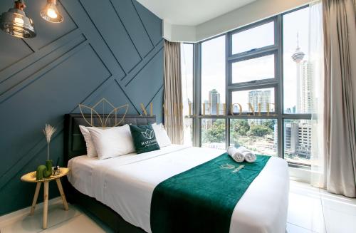 a bedroom with a large bed and a large window at The Robertson Kuala Lumpur in Kuala Lumpur