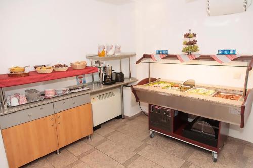 a kitchen with a counter with some food on it at Plus Hotel in Craiova