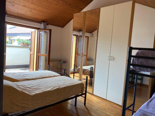 a bedroom with a bed and a large window at Casa Elvy Al Lago in Cannobio