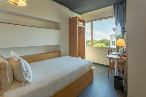 Säng eller sängar i ett rum på ONOMO Hotel Rabat Medina