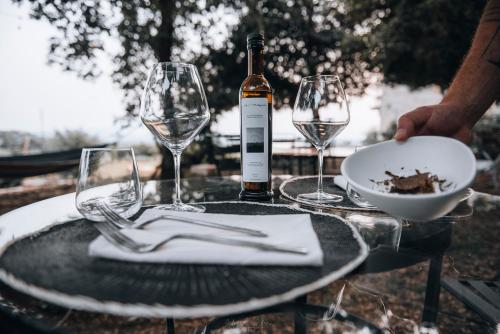 a table with a bottle of wine and two wine glasses at La casa del tartufo in Torri in Sabina