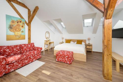 a bedroom with a bed and a couch at Unesco Prague Apartments in Prague