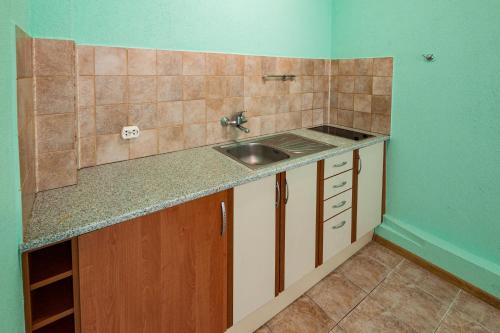 a kitchen with a sink and a counter top at Апартамент Морски бриз in Balchik