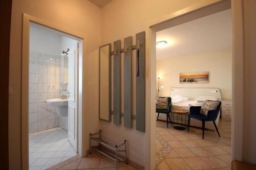 a bathroom with a bed and a table in a room at Villa Seydlitz - by Rujana in Binz