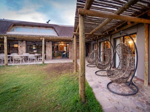a row of bikeulptures on the side of a house at Kamagu Safari Lodge in Touwsrivier