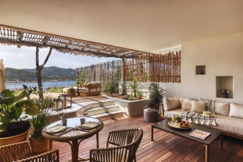 
a living room filled with furniture and a patio at Six Senses Ibiza in Portinatx
