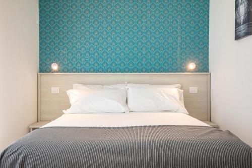 a bedroom with a bed with a green wall at Casa LiLu by Comorooms in Como