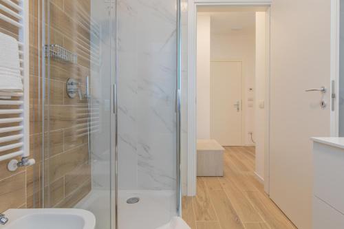 a bathroom with a shower with a toilet and a sink at Casa LiLu by Comorooms in Como