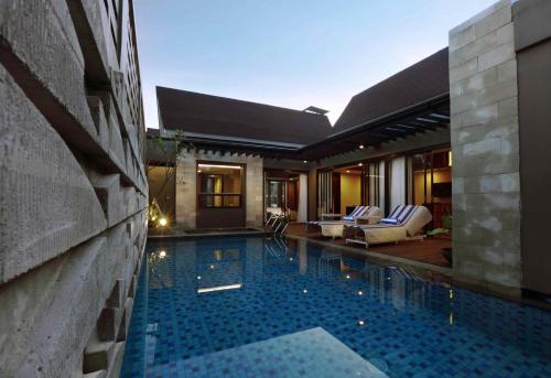 a swimming pool in the middle of a house at Aston Sentul Lake Resort & Conference Center in Bogor