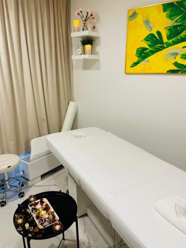 a hospital room with a table and a chair at Arche Hotel Krakowska in Warsaw