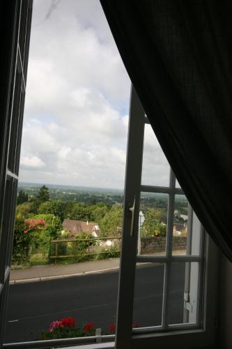 a window with a view of a road at Domfront - Numero CINQ in Domfront