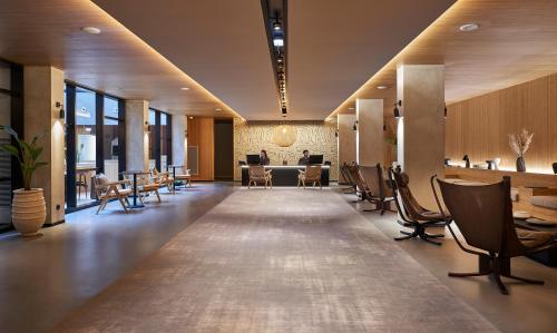 a lobby with a table and chairs in a building at PortoBay Teatro in Porto