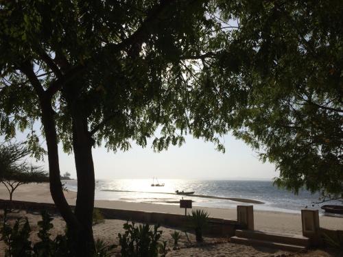 a view of a beach with a boat in the water at Mangrove House in Lamu