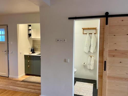 a bathroom with a door open to a kitchen at Casas Do Moinho - Turismo De Aldeia in Odeceixe