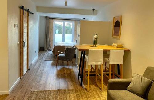 a living room with a table and chairs at Casas Do Moinho - Turismo De Aldeia in Odeceixe