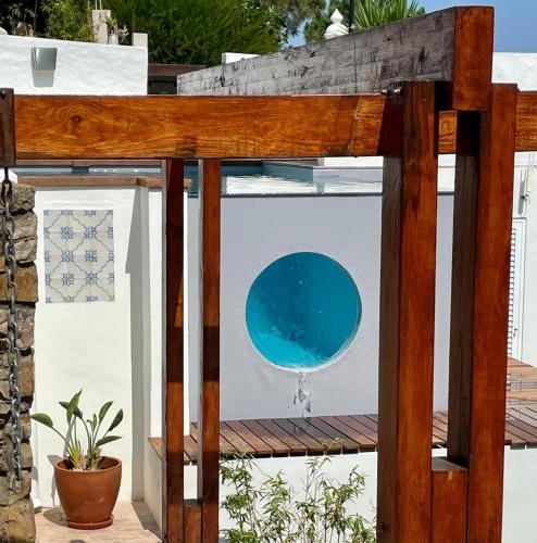 a wall with a picture of a blue circle on it at Casas Do Moinho - Turismo De Aldeia in Odeceixe
