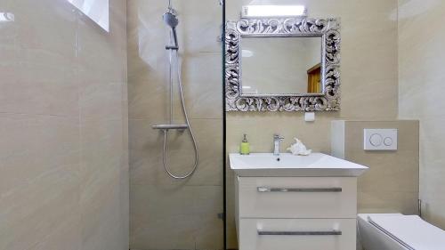 a bathroom with a shower and a sink and a mirror at Ron De Mar #3 modern room in Pezinok