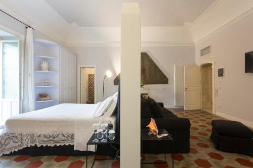 una camera con letto e un soggiorno di San Carlo Suites a Noto