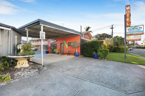 a gas station with a sign in front of it at Wunpalm Motel & Cabins - Late check-in available in Maroochydore